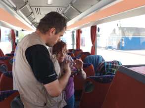 TSF staff helps a refugee rom Ukraine in a bus