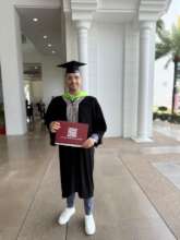 Adnan, proud and beaming in his convocation robe.