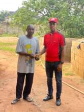 Our Project Leader supporting Mr Samuel with money