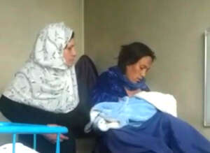 Mother and child after delivery with widwife