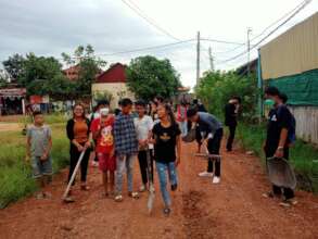 Our students help carry the red soil