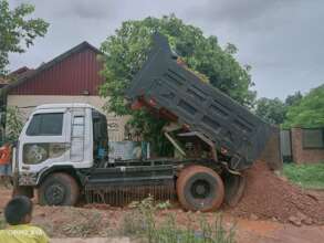 Truck drops down the red soil