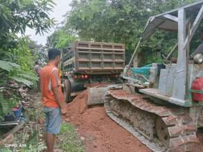Bulldozer machine move the earth to fix the roads
