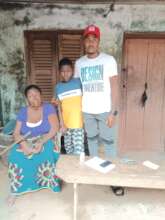 Our Project Leader with the orphan and grandmother