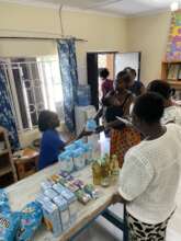 SHN staff member Elizabeth distributing food