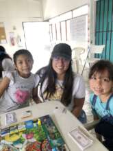 Paola, volunteer, and two girls