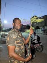 Mamadou with a plant marking World Environment Day