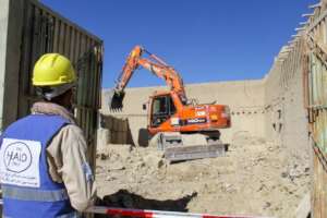 HALO team clear rubble using an excavator, Paktika