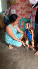 Child being weighed in his home