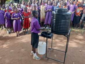A pupil teaching his colleagues how to wash hands