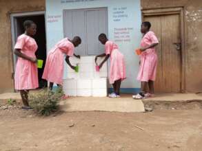 Pupils getting water from a water filter