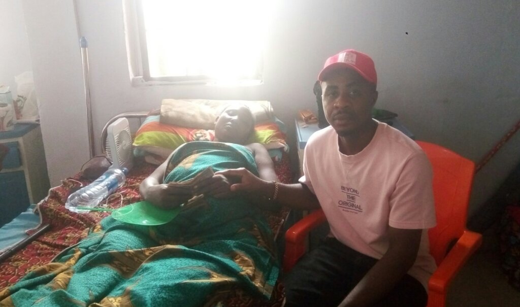 Our Project Leader supporting Mrs Mercy with money