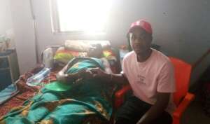 Our Project Leader supporting Mrs Mercy with money