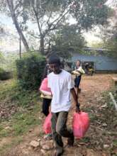 Local kids help with food distribution