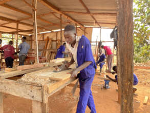 Beneficiaries training as wood carpenters