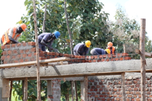 Beneficiaries learning bricklaying