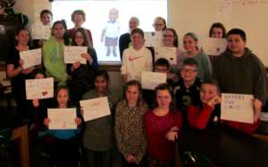 Palmyra students holding welcoming signs for Carl