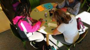 Palmyra students creating greeting cards for peers