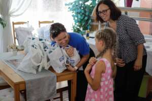 Colleen, left, distributes relief items in Romania