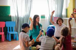 Cristina, second from right, leads music activity