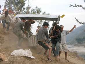 Villagers carry assembled chair to platform