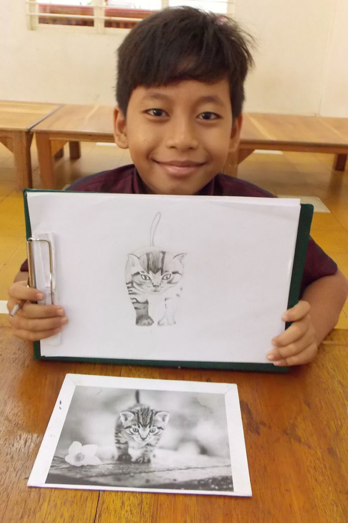 Student shows drawing he is working on