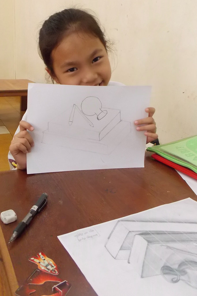 Artist, age 10, shows still life she is working on