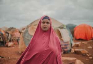 Amina standing in her campsite.