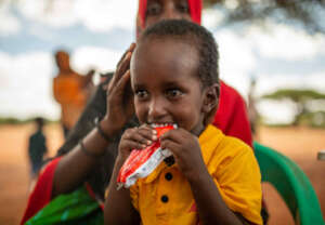 Zakaria (3) eats a nutrition supplement in Somalia
