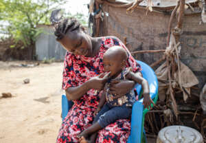 Refugee Mother Feeds Her Daughter