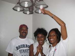 Volunteers Installing CFLs in Recipient's Home