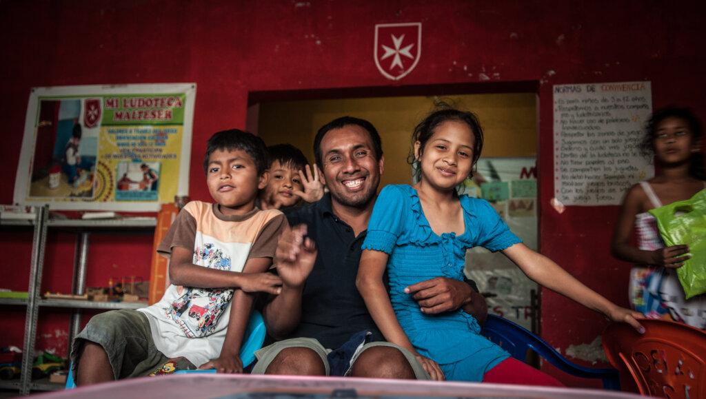 Feeding children in San Juan Bautista, Peru
