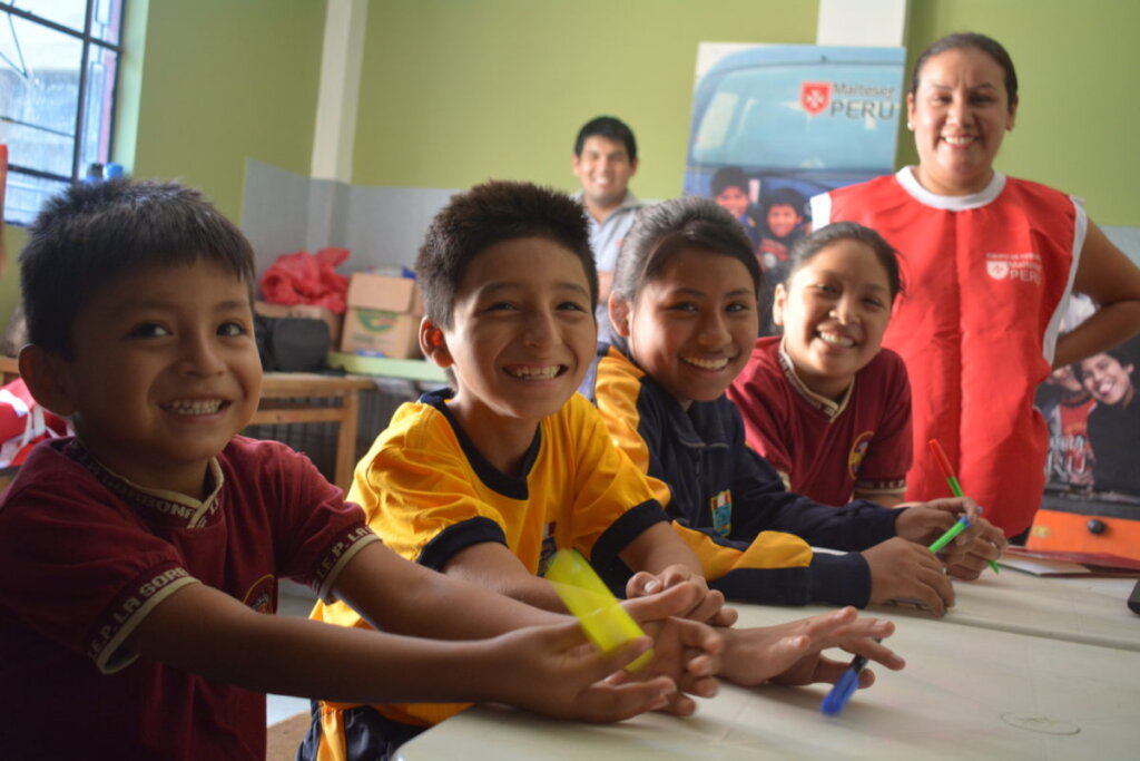Feeding children in San Juan Bautista, Peru
