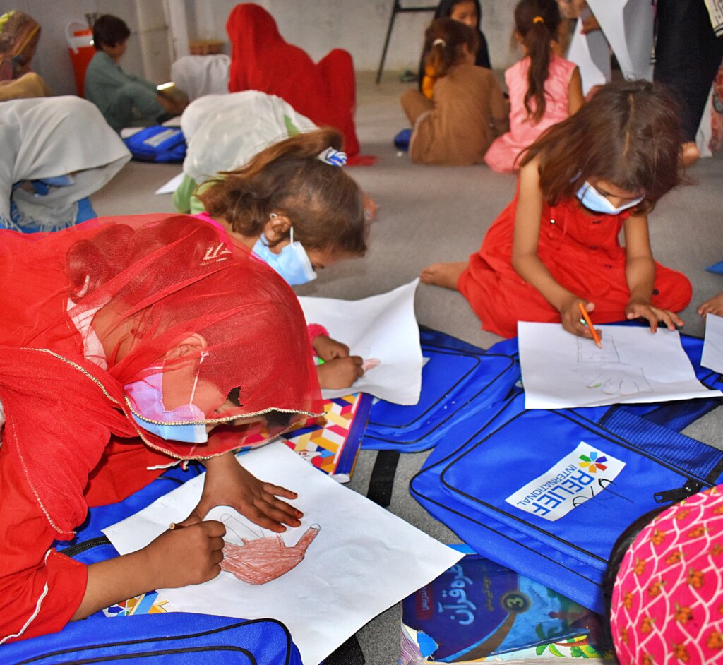 Children coloring using resources from RI