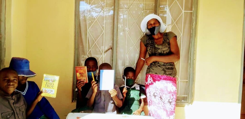 Reading in a mini Village school in Mele line