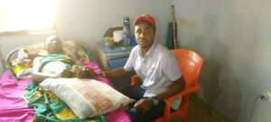 Our Project Leader supporting Mrs Mercy with money