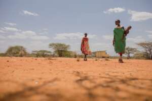 Two women walk toward a health center