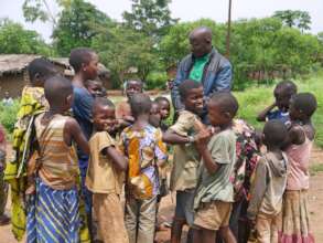 Jean Marie confers with Rwenena kids