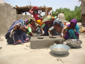 women learn how to make new cooking stove