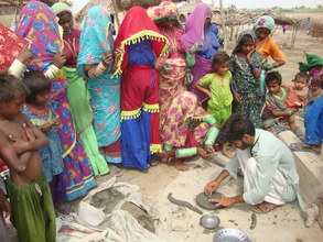 male helping women to learn FES cooking stove