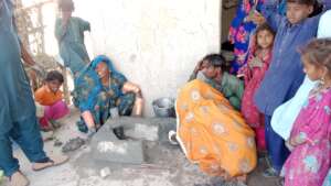 women making cooking stove
