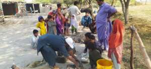 women making cooking stove