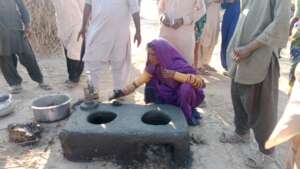 Women preparing cooking stove