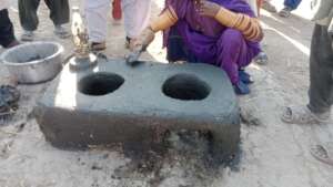 women making cooking stove