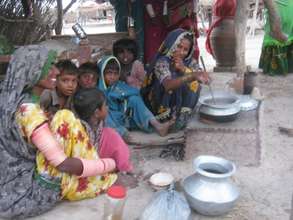 Family using cooking stove constructed flood area