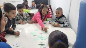 Children playing board games in a holiday workshop