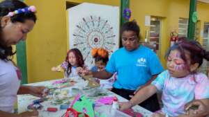 Children making costumes in a carnival workshop.