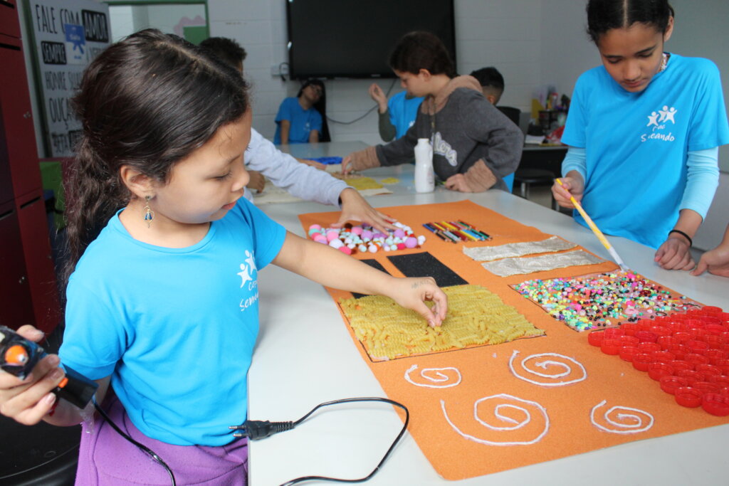 Children creating art with pasta