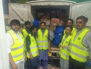 Volunteers loading cartons of clothes