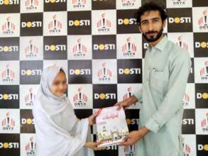 a child receives books from the director